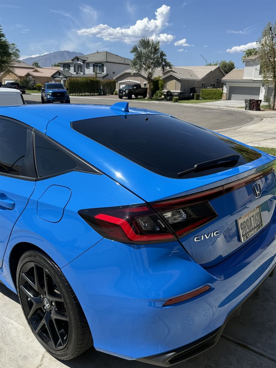 Blue Honda Civic rear quarter panel after paint correction, glossy with no water spots