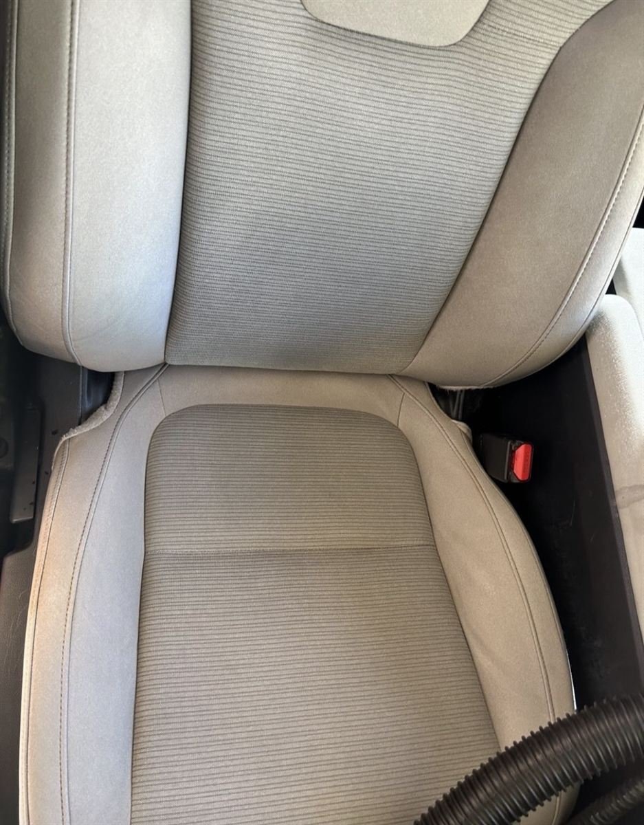 Tan cloth car seat after a deep interior clean, stain-free