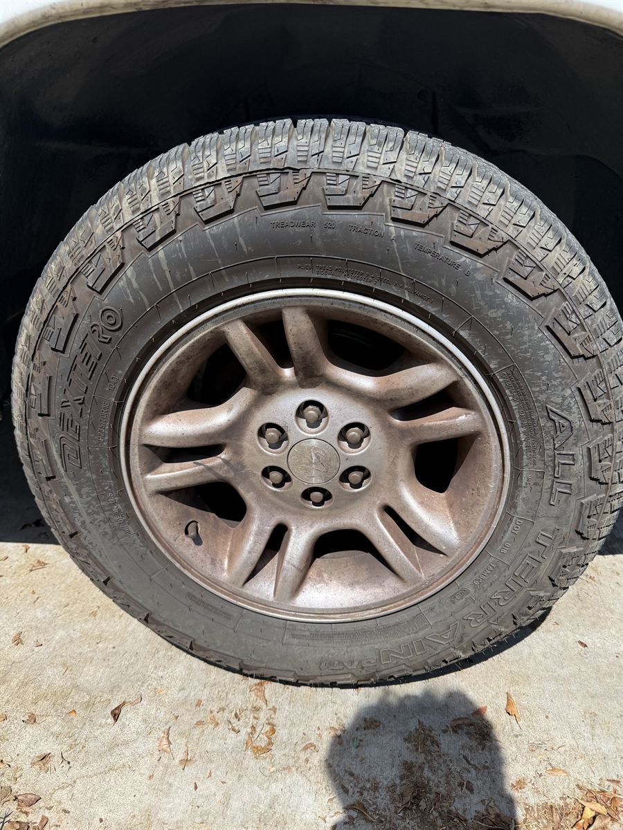 Same truck wheel before, coated in brake dust and grime