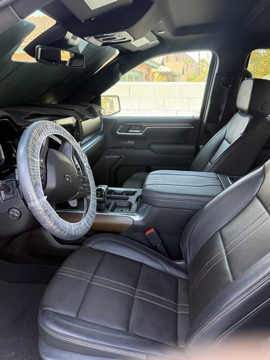Detailed truck interior with clean black leather seats and dashboard